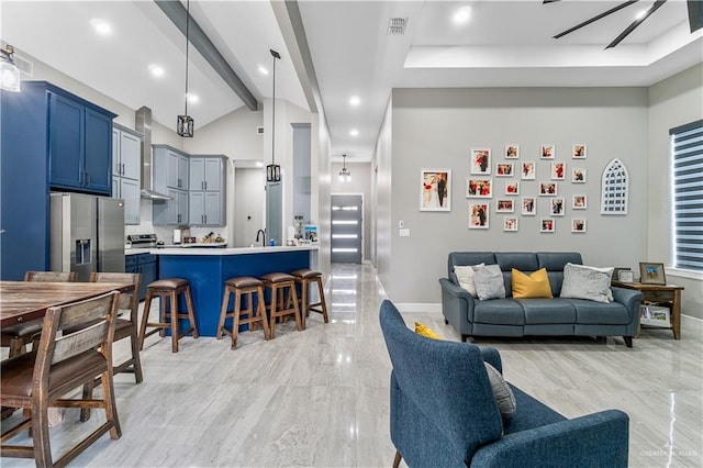 living room featuring vaulted ceiling with beams and sink