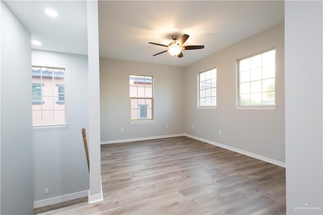 unfurnished room with light hardwood / wood-style floors, ceiling fan, and a healthy amount of sunlight