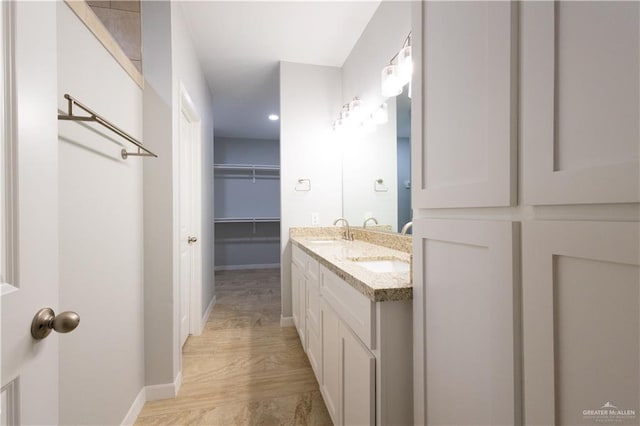 bathroom featuring vanity and wood-type flooring