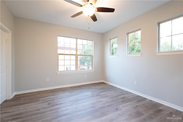 unfurnished room with hardwood / wood-style floors and ceiling fan