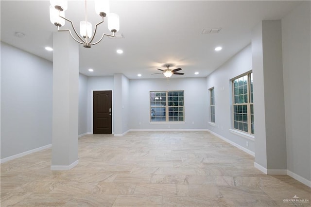 spare room with ceiling fan with notable chandelier