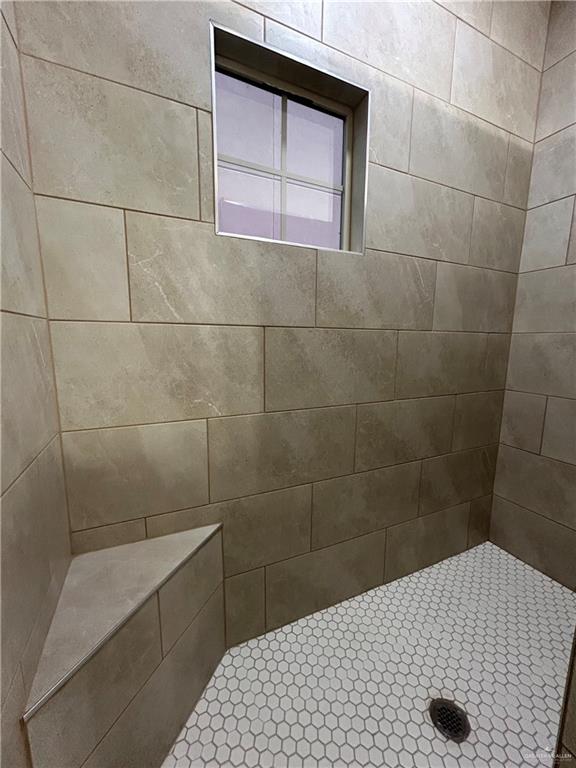 bathroom with tiled shower