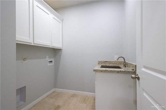 laundry area featuring sink, cabinets, and washer hookup