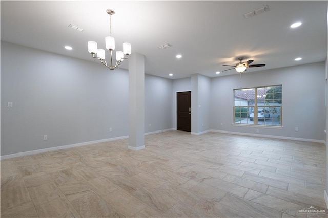 empty room featuring ceiling fan with notable chandelier