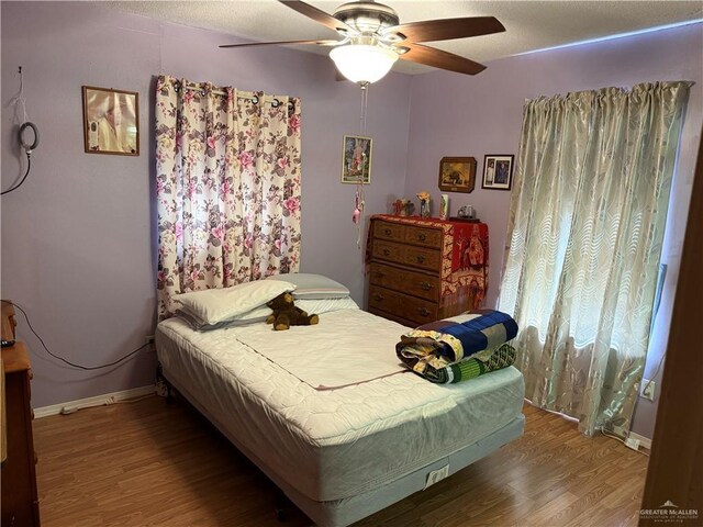219 San Pedro St, Edinburg, TX 78542 - bedroom with wood finished floors and a ceiling fan