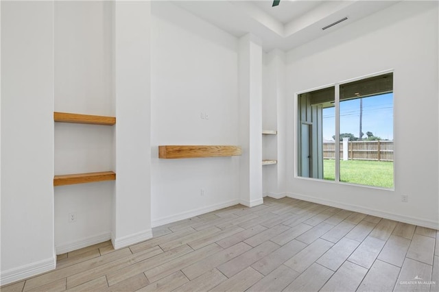 2413 N Gaytan Ave, Edinburg, TX 78542 - empty room featuring wood finished floors, baseboards, and a raised ceiling