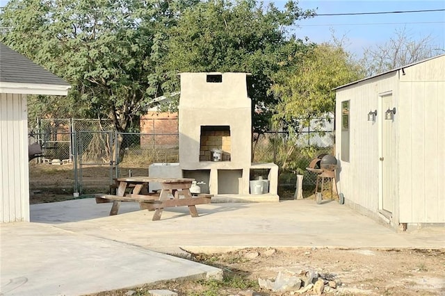 view of patio featuring area for grilling and an outdoor fireplace