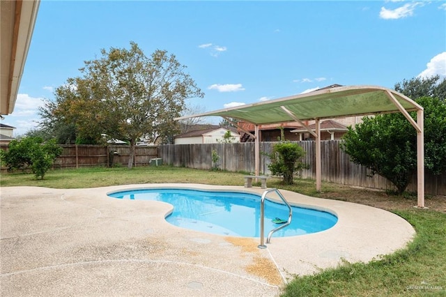 view of swimming pool featuring a yard and a patio area