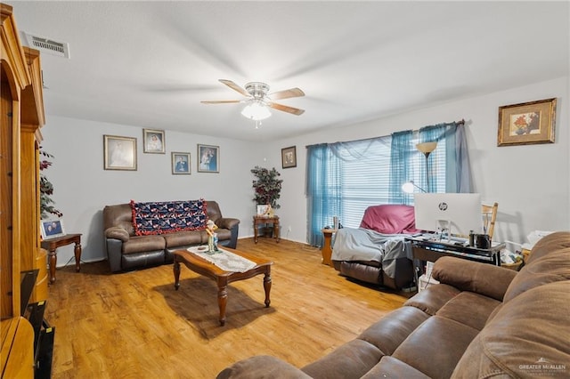 living room featuring ceiling fan and light wood-type flooring