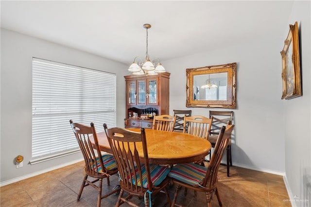 dining room featuring tile patterned flooring and an inviting chandelier