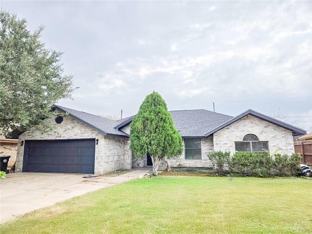 view of front of home featuring a garage, brick siding, a shingled roof, driveway, and a front lawn