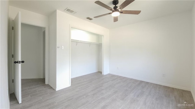 unfurnished bedroom with a closet, visible vents, light wood-style flooring, and baseboards