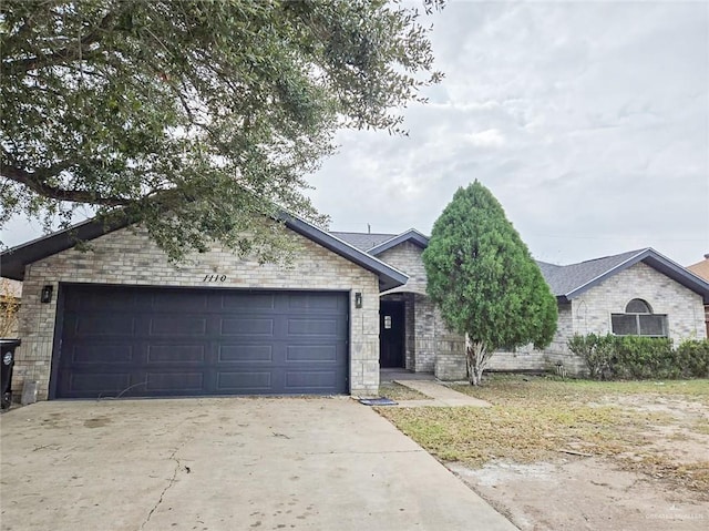 single story home with an attached garage, concrete driveway, and brick siding