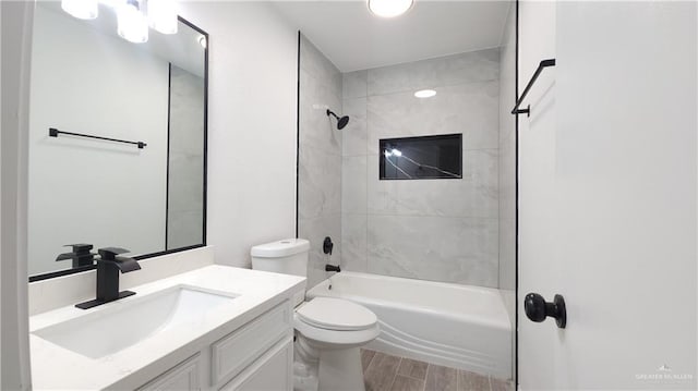 bathroom featuring vanity,  shower combination, wood finished floors, and toilet