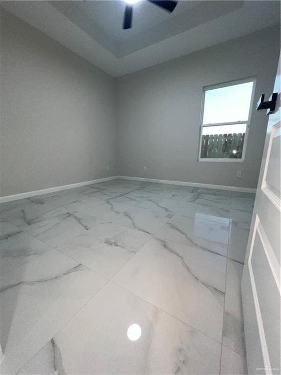 409 S 12th St, Alamo, TX 78516 - unfurnished room featuring marble look tile flooring, baseboards, and a ceiling fan