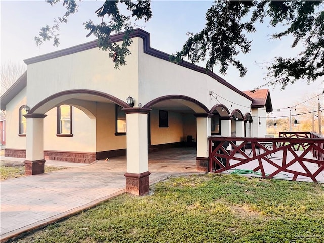 rear view of house featuring a lawn