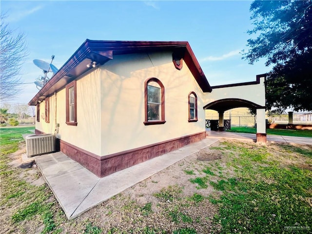 view of side of home featuring central AC and a patio area