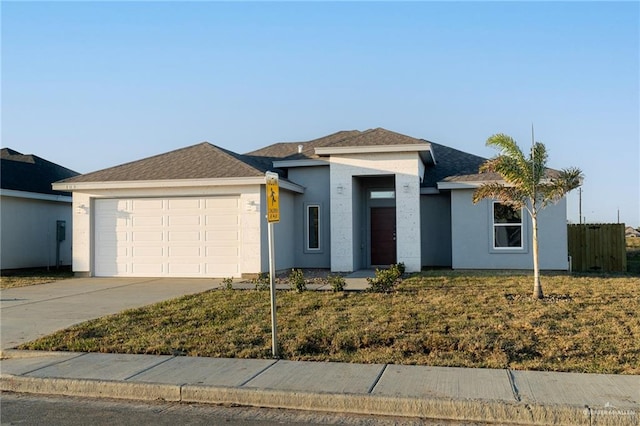 view of front facade with an attached garage, concrete driveway, and stucco siding