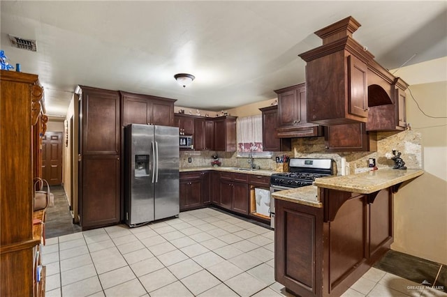 kitchen featuring decorative backsplash, appliances with stainless steel finishes, kitchen peninsula, sink, and light tile patterned floors