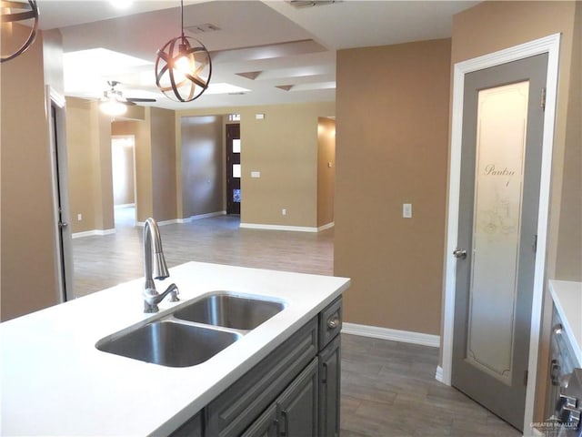 5421 San Diego Dr, Edinburg, TX 78542 - kitchen with a sink, a ceiling fan, light countertops, wood finished floors, and baseboards