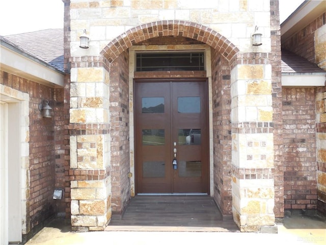 5421 San Diego Dr, Edinburg, TX 78542 - entrance to property with french doors, stone siding, a shingled roof, and brick siding