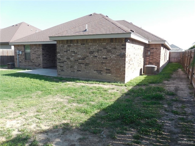 5421 San Diego Dr, Edinburg, TX 78542 - back of house featuring brick siding, a patio, central AC, and a shingled roof