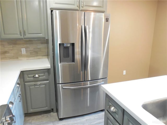 5421 San Diego Dr, Edinburg, TX 78542 - kitchen with stainless steel fridge, backsplash, and light countertops