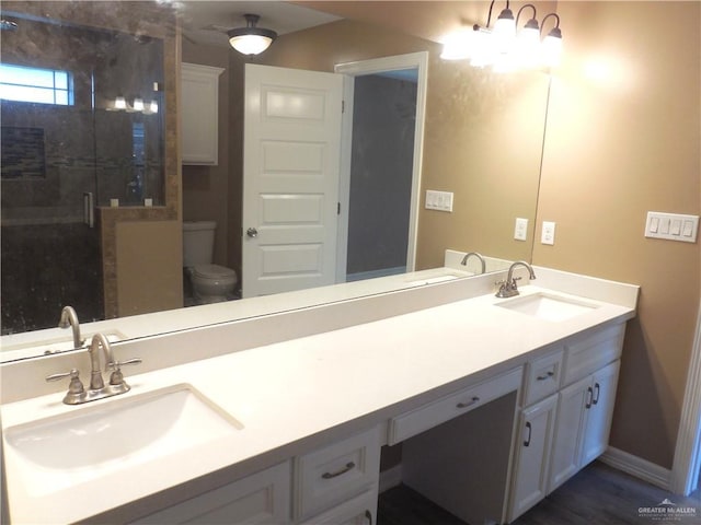 5421 San Diego Dr, Edinburg, TX 78542 - bathroom featuring double vanity, a stall shower, toilet, and baseboards