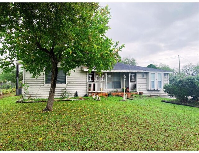 view of front facade with central air condition unit and a front yard