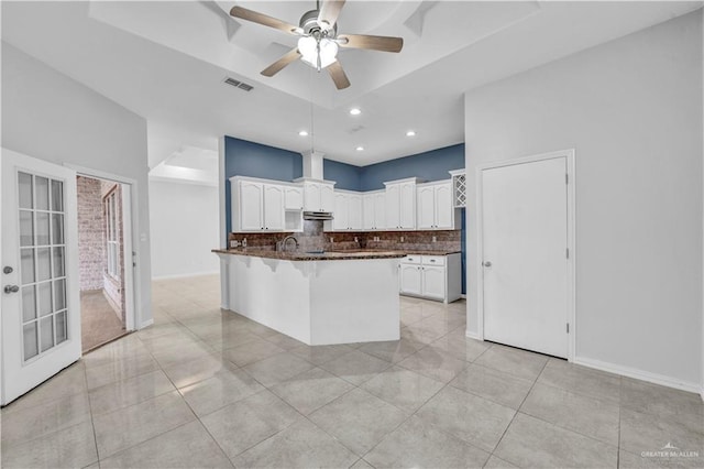 kitchen with white cabinetry, ceiling fan, tasteful backsplash, and light tile patterned floors