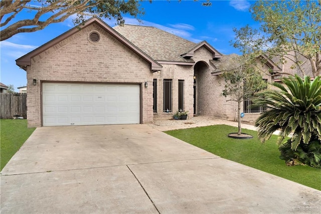 view of front facade featuring a garage and a front lawn