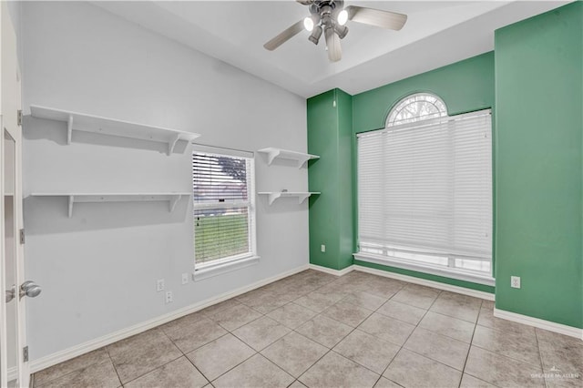 spare room featuring ceiling fan and light tile patterned flooring