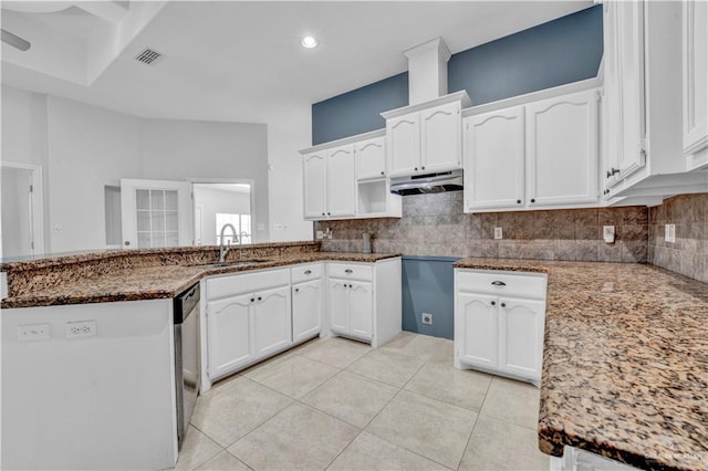 kitchen with stone countertops, sink, and white cabinets