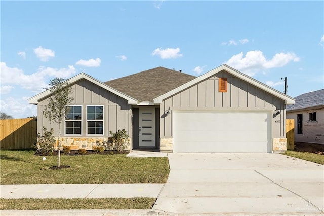 view of front facade with a garage and a front lawn