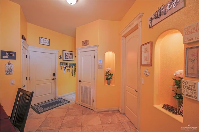 foyer featuring light tile patterned floors