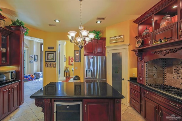 kitchen featuring wine cooler, a kitchen island, light tile patterned flooring, and appliances with stainless steel finishes