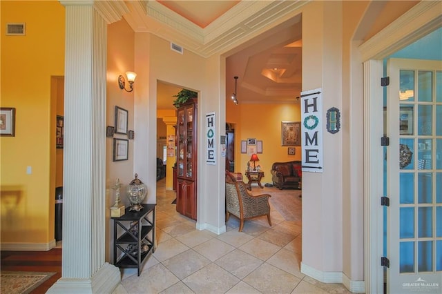 hall featuring crown molding and light tile patterned floors