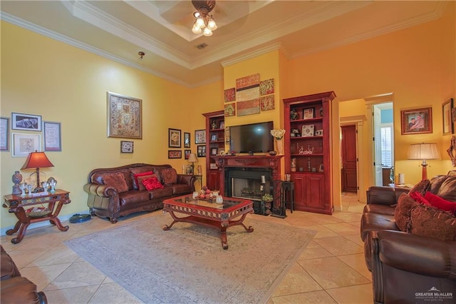 tiled living room featuring ceiling fan, a raised ceiling, crown molding, and a high ceiling