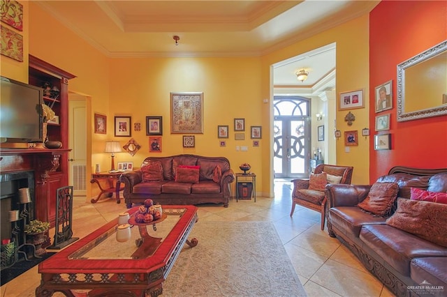 tiled living room featuring a tray ceiling and crown molding