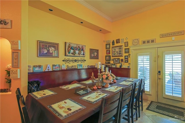 dining room with light tile patterned floors, crown molding, and french doors