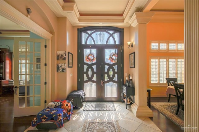 tiled foyer entrance with ornamental molding and french doors