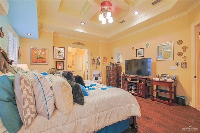 bedroom featuring hardwood / wood-style flooring, a raised ceiling, ceiling fan, and crown molding