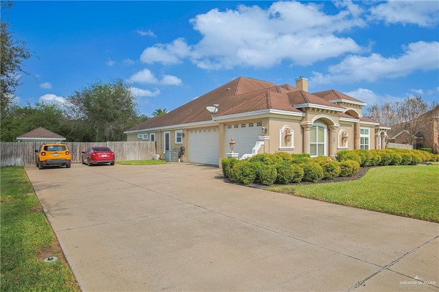 view of front of property with central AC unit, a garage, and a front lawn