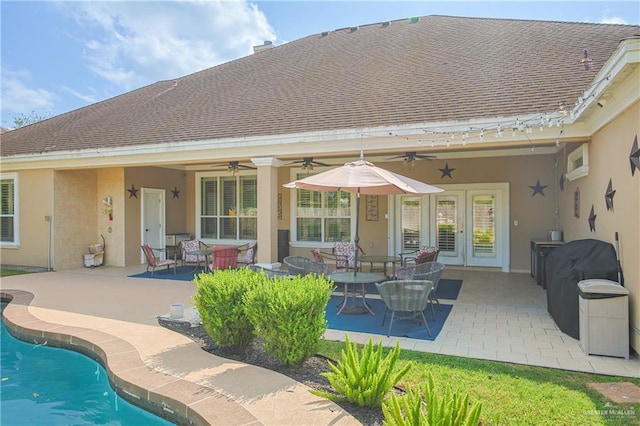 rear view of house featuring ceiling fan and a patio area