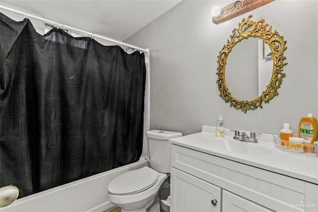 full bathroom featuring shower / bath combo, vanity, and toilet