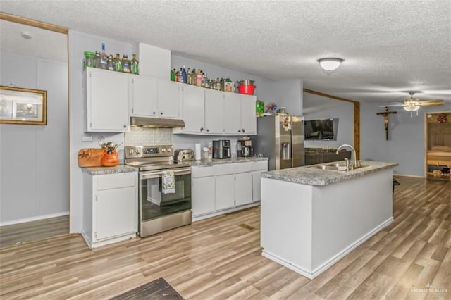 kitchen featuring ceiling fan, white cabinets, stainless steel appliances, and a textured ceiling