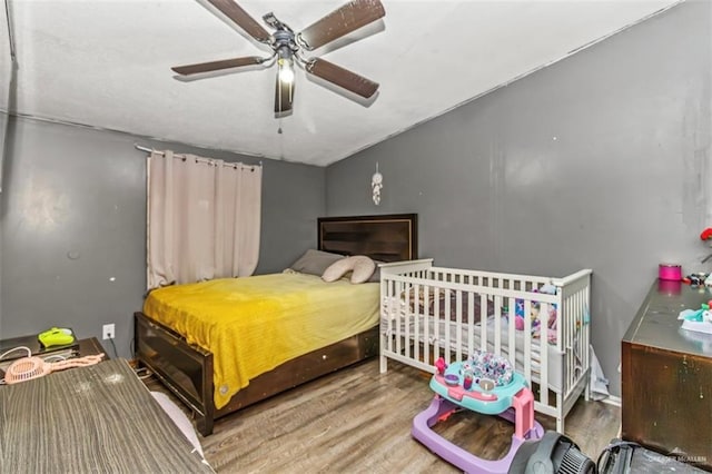 bedroom with hardwood / wood-style flooring and ceiling fan