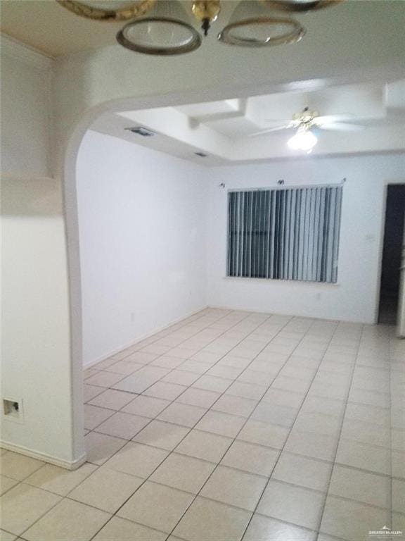 empty room featuring ceiling fan and light tile patterned flooring