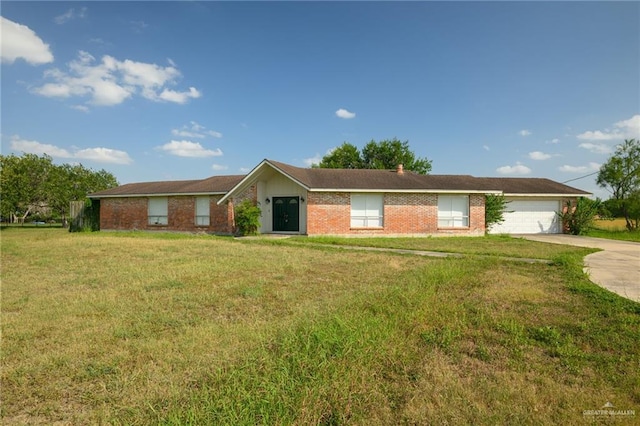 15220 Wilson Rd, Harlingen, TX 78552 - ranch-style house featuring driveway, a front lawn, a garage, and brick siding