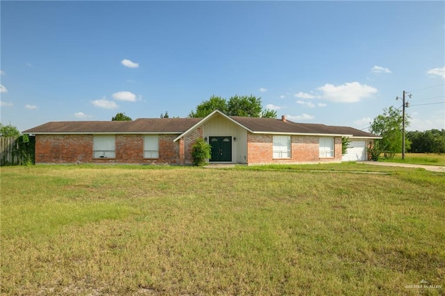 15220 Wilson Rd, Harlingen, TX 78552 - single story home featuring an attached garage, a front lawn, concrete driveway, and brick siding